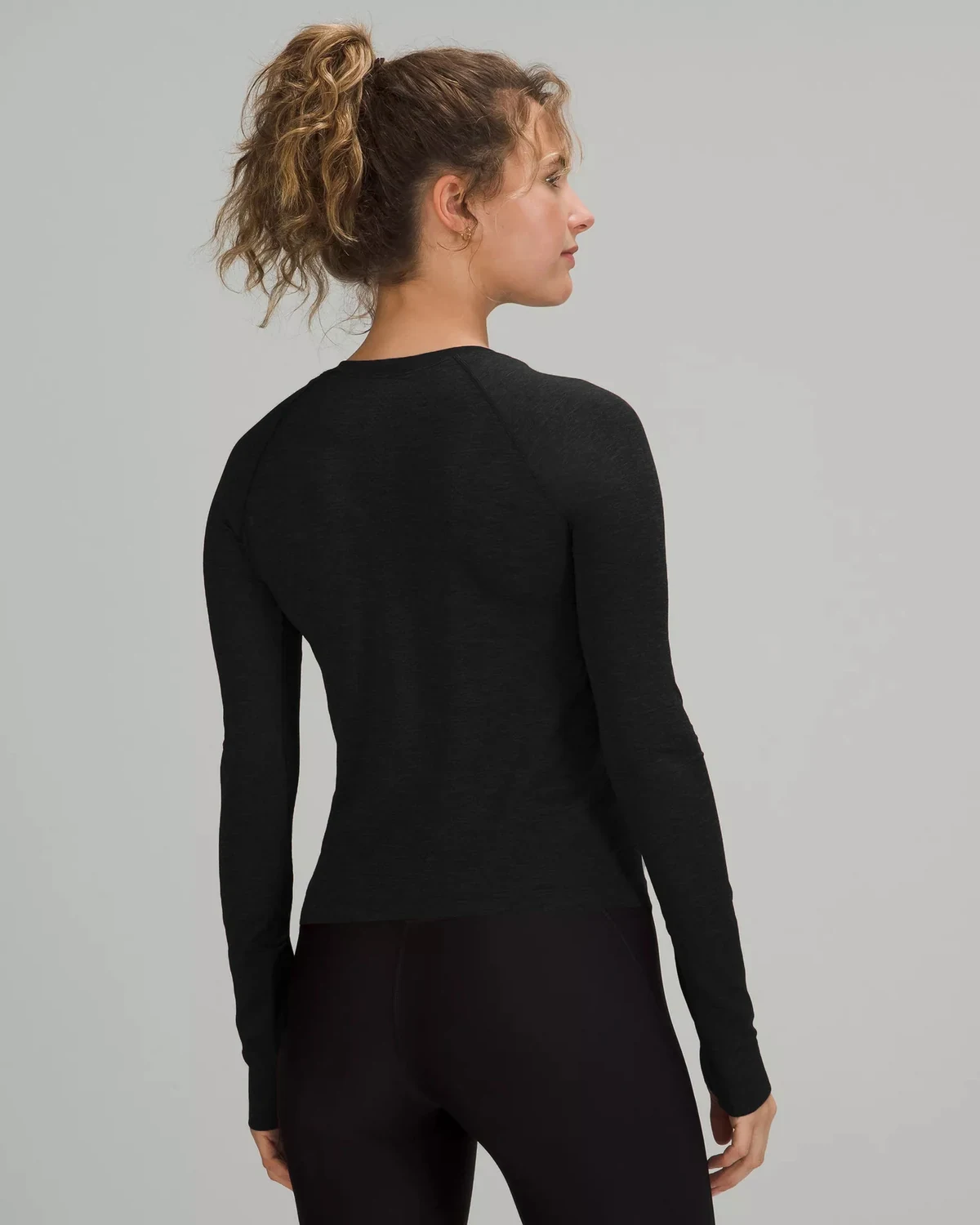 Raglan women's sports long-sleeve top with thumbholes, quick-dry fitted, styled view
